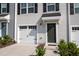 Townhouse exterior with a dark green door and white garage at 1109 Pale Moss Dr, Durham, NC 27704