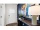 Bright entryway with a white door, dark wood console table, and abstract art at 65 Ethel Ln, Angier, NC 27501