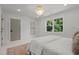 Bright bedroom with double doors and a window offering natural light at 2801 Ashland St, Raleigh, NC 27608