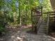 Wooded backyard with a deck and wooden steps at 111 N Coslett Ct, Cary, NC 27513