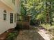 Deck with pergola and steps leading to a wooded backyard at 111 N Coslett Ct, Cary, NC 27513