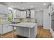 Modern kitchen with white cabinets, granite island, and stainless steel appliances at 111 N Coslett Ct, Cary, NC 27513
