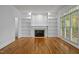 Gathering room with hardwood floors, fireplace, and built-in shelves at 111 N Coslett Ct, Cary, NC 27513
