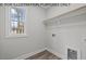 Laundry room with built-in shelving, window, and wood-look flooring at 102 Mayan Dr, Louisburg, NC 27549