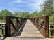 Rustic footbridge with wooden deck and metal railings at 4929 Trout Crest Court, Raleigh, NC 27604