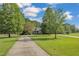 Brick home with circular driveway and large green lawn at 1100 Branch Chapel Church Rd, Selma, NC 27576