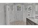Large walk-in shower with marble tile and pebble floor at 1100 Branch Chapel Church Rd, Selma, NC 27576