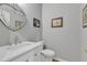 Small bathroom with white vanity, heart-shaped mirror, and toilet at 1100 Branch Chapel Church Rd, Selma, NC 27576