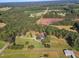 Aerial view of house on large lot with circular driveway, barn, and pastures at 1100 Branch Chapel Church Rd, Selma, NC 27576
