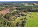 Aerial view showcasing a house with a long driveway, surrounded by trees and pastures at 1100 Branch Chapel Church Rd, Selma, NC 27576
