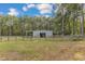 Metal barn with open sides and fenced pasture at 1100 Branch Chapel Church Rd, Selma, NC 27576