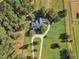 Aerial view of house with circular driveway, surrounded by green lawns and trees at 1100 Branch Chapel Church Rd, Selma, NC 27576