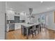 Modern kitchen with white cabinets, quartz countertops, and a large island at 1100 Branch Chapel Church Rd, Selma, NC 27576