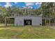 Metal barn with covered overhangs and fenced area at 1100 Branch Chapel Church Rd, Selma, NC 27576