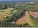 Aerial view of house situated on a large lot with adjacent pastures and stables at 1100 Branch Chapel Church Rd, Selma, NC 27576