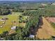 Aerial view of property showing house, expansive land, and nearby stables at 1100 Branch Chapel Church Rd, Selma, NC 27576