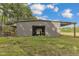 Gray metal barn with visible interior stalls at 1100 Branch Chapel Church Rd, Selma, NC 27576