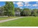 Brick home with circular driveway, lush landscaping, and spacious yard at 1100 Branch Chapel Church Rd, Selma, NC 27576