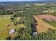 Aerial view showing a house, large green fields, and nearby stables at 1100 Branch Chapel Church Rd, Selma, NC 27576
