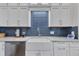 White shaker cabinets, a farmhouse sink, and blue tile backsplash at 1100 Branch Chapel Church Rd, Selma, NC 27576