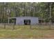 Gray metal barn with large roll-up door at 1100 Branch Chapel Church Rd, Selma, NC 27576