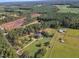 Aerial view of a home on a large lot with a circular driveway and nearby stables at 1100 Branch Chapel Church Rd, Selma, NC 27576