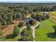 Aerial view showing a house with a circular driveway, surrounded by lush greenery at 1100 Branch Chapel Church Rd, Selma, NC 27576