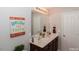 Bathroom featuring double sinks and decorative wall art at 700 Quail Ct, Creedmoor, NC 27522