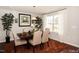 Bright dining room with hardwood floors and a rustic wooden table at 700 Quail Ct, Creedmoor, NC 27522