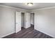 Bedroom with double door closet and wood-look floors at 225 W Orange St, Hillsborough, NC 27278