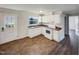 White kitchen with brown tile floor and stainless steel appliances at 225 W Orange St, Hillsborough, NC 27278