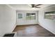 Bedroom with wood-look flooring, white door, and windows at 225 W Orange St, Hillsborough, NC 27278