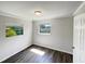 Simple bedroom with wood-look floors and neutral walls at 225 W Orange St, Hillsborough, NC 27278