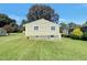 Rear view of house with green siding and large yard at 225 W Orange St, Hillsborough, NC 27278