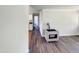 Hallway with wood-look floors and access to kitchen at 225 W Orange St, Hillsborough, NC 27278