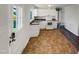 Kitchen with white cabinets, granite countertops and tile floors at 225 W Orange St, Hillsborough, NC 27278