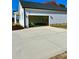 New construction home with attached two-car garage and driveway at 15 Bella Ln, Zebulon, NC 27597