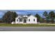 White farmhouse exterior with a landscaped lawn at 15 Bella Ln, Zebulon, NC 27597