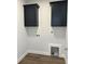 Laundry room with dark cabinets and vinyl flooring at 15 Bella Ln, Zebulon, NC 27597