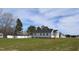White house exterior with a large backyard at 15 Bella Ln, Zebulon, NC 27597