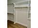 Bright walk-in closet featuring built-in shelves and rods at 15 Bella Ln, Zebulon, NC 27597