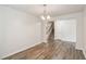 Dining room with gray vinyl flooring, light fixture and view of staircase at 817 Leatherstone Ln, Fuquay Varina, NC 27526
