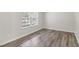 Spare bedroom with gray vinyl flooring and a large window at 817 Leatherstone Ln, Fuquay Varina, NC 27526