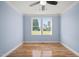 Bright bedroom with hardwood floors and large windows offering a view of the backyard at 2804 Jack Mitchell Rd, Zebulon, NC 27597