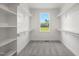 Large walk-in closet with ample shelving and gray carpeting at 2804 Jack Mitchell Rd, Zebulon, NC 27597