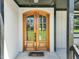 Elegant double wooden front door with arched glass panels at 2804 Jack Mitchell Rd, Zebulon, NC 27597