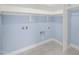 Laundry room with built-in shelving and tile flooring at 2804 Jack Mitchell Rd, Zebulon, NC 27597