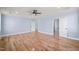 Main bedroom with hardwood floors, ceiling fan, and access to two bathrooms at 2804 Jack Mitchell Rd, Zebulon, NC 27597