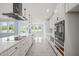 Long kitchen with white cabinets, stainless steel appliances, and a large island at 2804 Jack Mitchell Rd, Zebulon, NC 27597