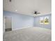 Light-filled bedroom with grey carpet and two windows at 2804 Jack Mitchell Rd, Zebulon, NC 27597